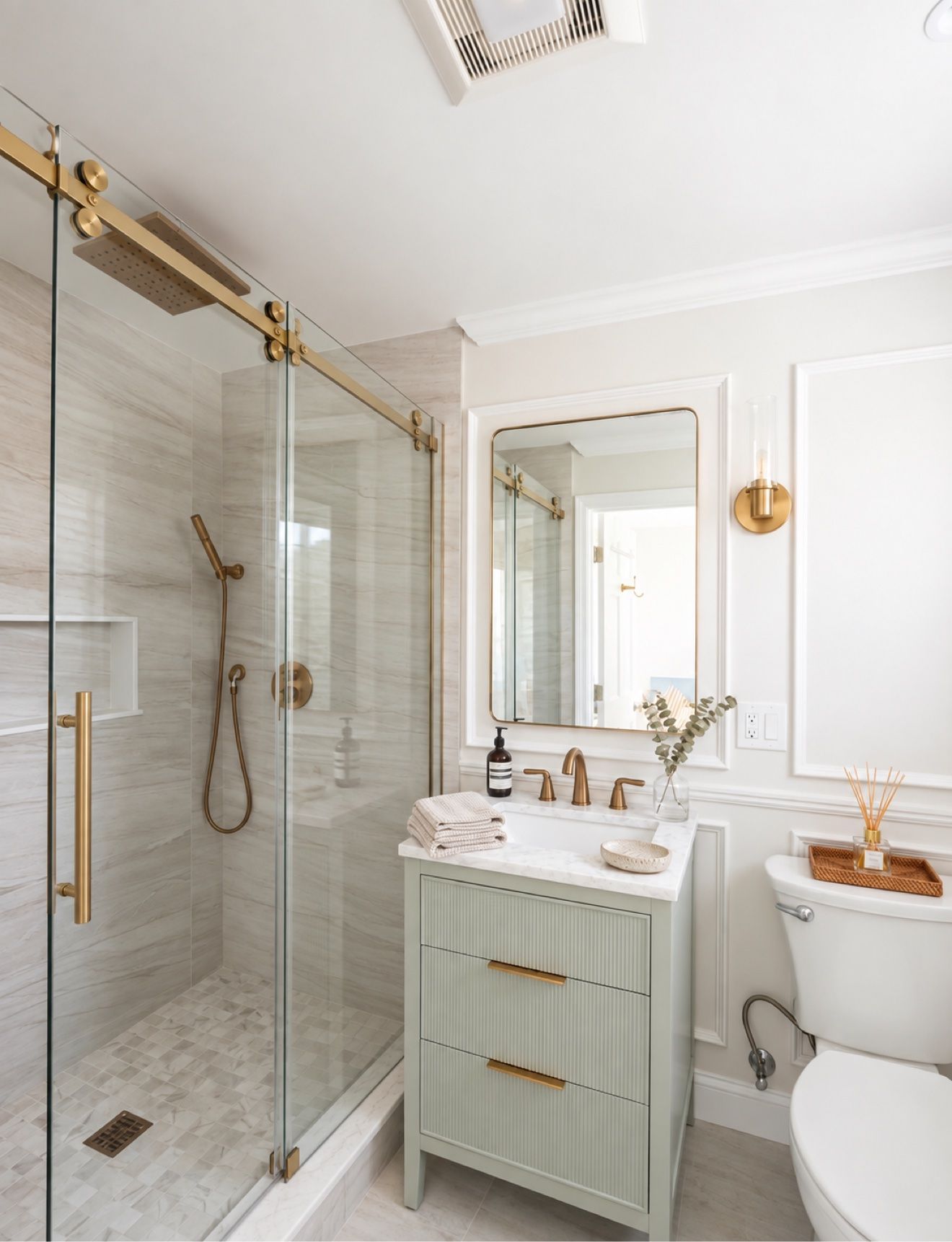 Renovated downstairs bathroom with glass walk-in rain shower, brass fixtures, and sage vanity
