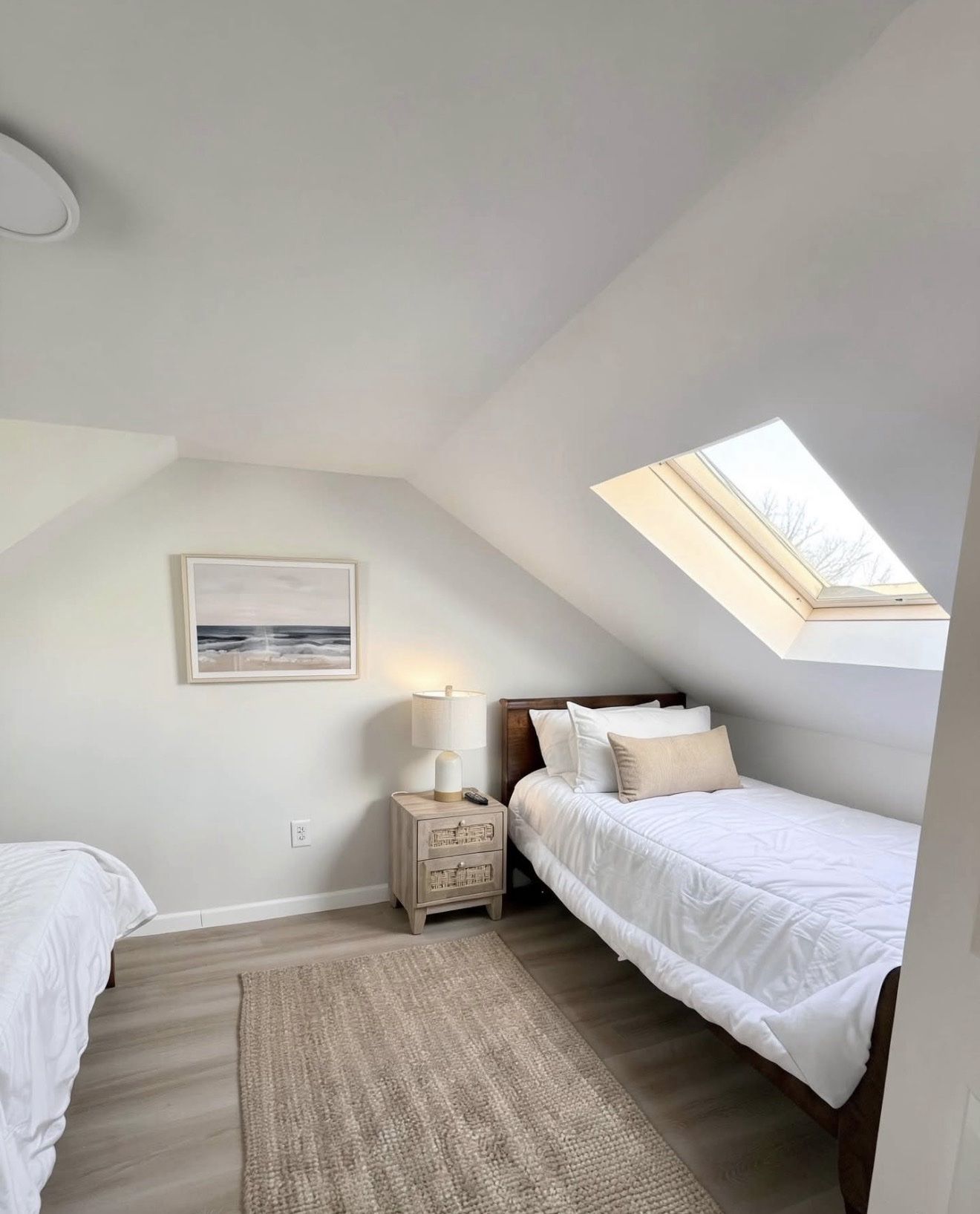 Upstairs twin bedroom with skylight under the eaves
